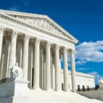 Supreme Court building with marble columns under blue sky