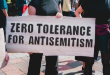 Protester holding a large sign at a rally