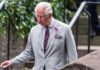 Rare Palace Rebuke Shocks Royals Watchers older man in a light gray suit walking outdoors