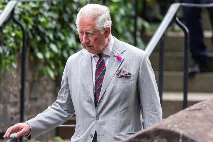 older man in a light gray suit walking outdoors