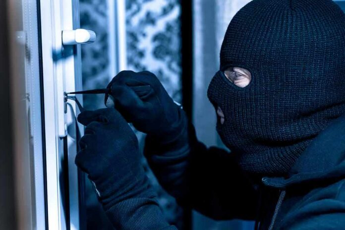 shutterstock_1751741492 Masked person picking a door lock