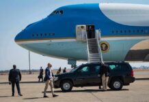 Aggressive Itinerary Maps The Midterm Battleground Security detail near blue and white aircraft with staircase and SUV