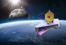 space telescope with gold hexagonal mirror orbiting above Earth