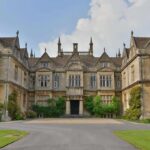 Historic mansion with ornate stone facade and gabled roofs