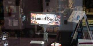 Bookstore window display with banned books sign