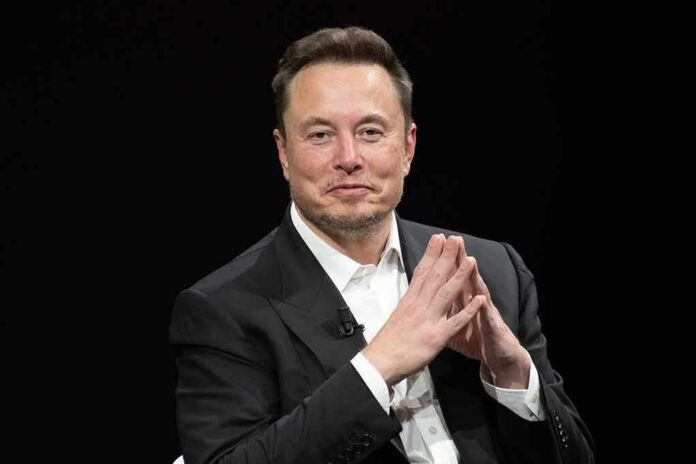 Elon Musk seated in a black suit with hands clasped