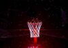Basketball hoop glowing under red spotlight
