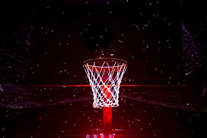 Basketball hoop glowing under red spotlight