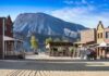 Old western town set against a mountain backdrop