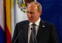 Vladimir Putin at a podium during a formal event