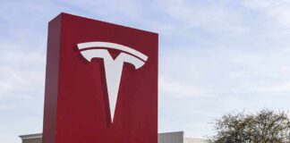 Tesla dealership sign in front of parking lot