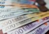 Euro banknotes fanned out on a surface
