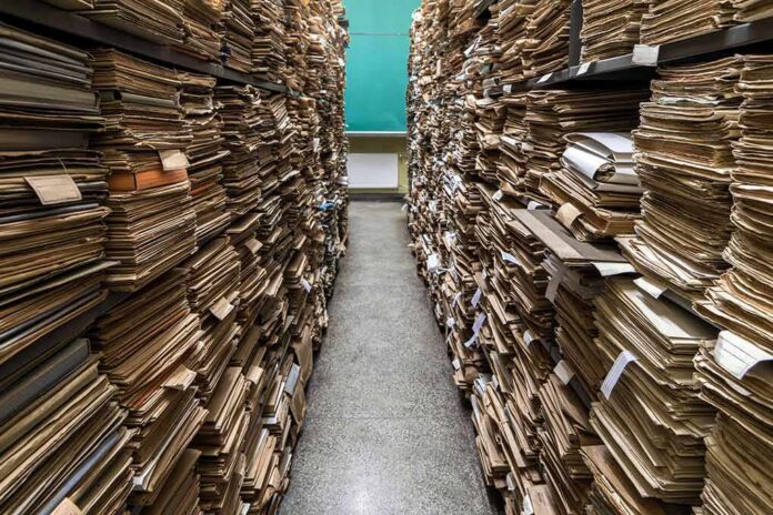 Aisle between shelves stacked with old paper files