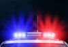 Police car roof with flashing red and blue lights at night