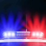Police car roof with flashing red and blue lights at night