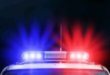 Police car roof with flashing red and blue lights at night