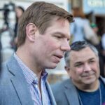 Eric Swalwell speaking with people at an outdoor event