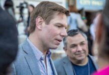 Eric Swalwell speaking with people at an outdoor event