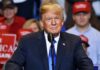 Donald Trump speaking at a rally podium