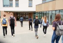 Utah Clash Erupts Over Two-Genders Sign Students with backpacks walking toward a school entrance