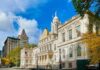 Tradition Killed – Jobs on the Line City hall building with classical architecture under a blue sky