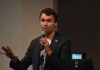 Rifle Link Crumbles – What’s Missing? man speaking into a microphone during a talk