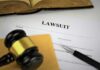 Defamation Firestorm Erupts Before Senate Heat Lawsuit documents with gavel, pen, and legal book