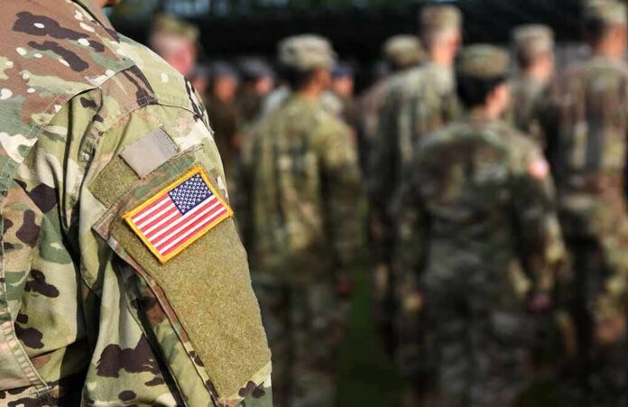 Soldier in camouflage with U.S. flag patch at formation