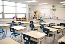 Visible Leg Mark Triggers Child-Abuse Charge Empty classroom with rows of student desks and chairs