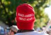 person wearing a red baseball cap at an outdoor gathering