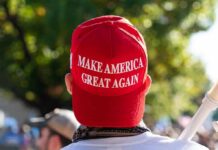 person wearing a red baseball cap at an outdoor gathering