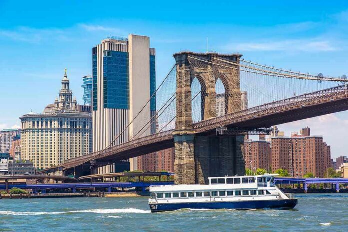 Brooklyn Bridge with ferry on the East River