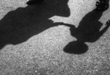 Visible Difference, Ugly Moment Shadows of an adult and a child holding hands on pavement