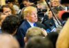 Donald Trump speaks to reporters in a crowded media scrum