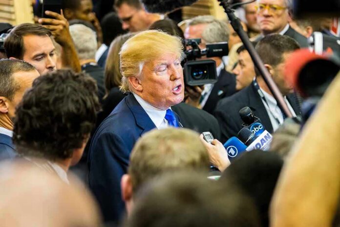 shutterstock_519150601 Donald Trump speaks to reporters in a crowded media scrum