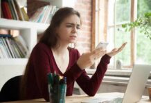 Backfire Alert: Spam Costs Votes Woman frustrated with smartphone at desk